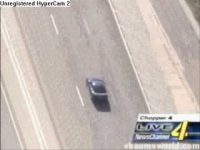 Car speeding on highway during news broadcast