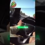 Person driving car on highway, steering wheel view.