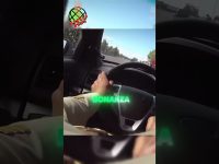 Person driving car on highway, steering wheel view.