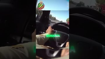 Person driving car on highway, steering wheel view.