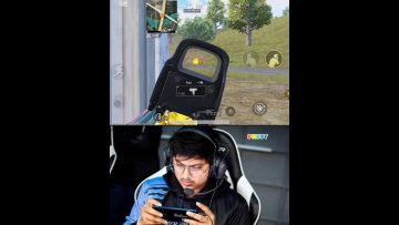 Person playing mobile shooting game with focus