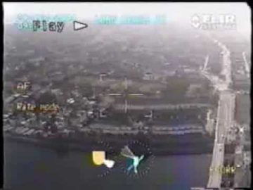 Aerial video footage of urban landscape with roads.