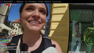 Woman smiling outdoors with sunny background in Prague.
