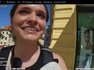 Woman smiling outdoors with sunny background in Prague.