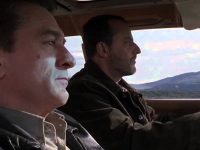 Two men driving through scenic mountains