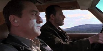 Two men driving through scenic mountains
