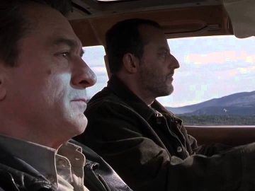 Two men driving through scenic mountains