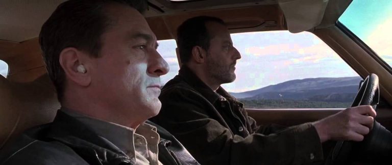 Two men driving through scenic mountains