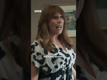 Woman speaking passionately in patterned dress.