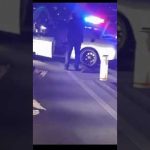 Police car with flashing lights at night scene.