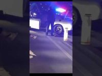 Police car with flashing lights at night scene.