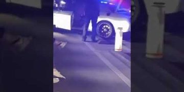 Police car with flashing lights at night scene.