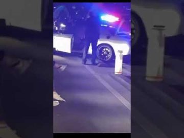 Police car with flashing lights at night scene.