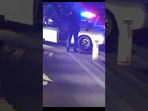 Police car with flashing lights at night scene.