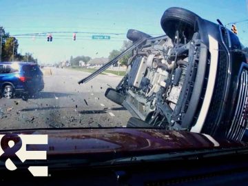 Two-car collision at intersection with flipped vehicle.