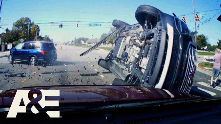 Two-car collision at intersection with flipped vehicle.