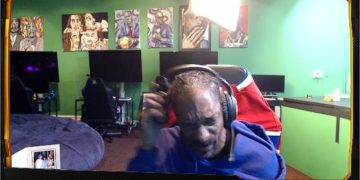 Person in gaming room with art in the background