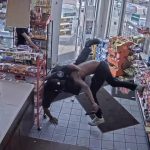 CCTV captures store wrestling near snack aisle.