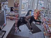 CCTV captures store wrestling near snack aisle.