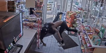 CCTV captures store wrestling near snack aisle.