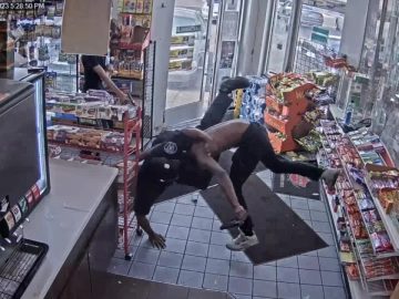 CCTV captures store wrestling near snack aisle.