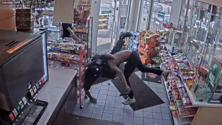 CCTV captures store wrestling near snack aisle.