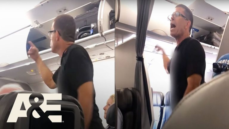 Passenger arguing on airplane near luggage compartment.