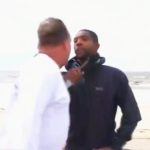 Two men arguing on a beach