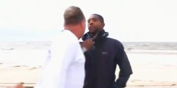 Two men arguing on a beach