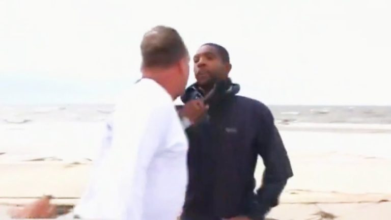 Two men arguing on a beach