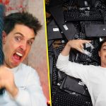 Man holding keyboard, lying on pile of keyboards