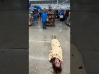 Woman wrapped in tortilla blanket in store aisle