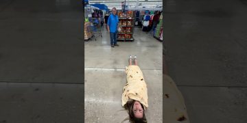 Woman wrapped in tortilla blanket in store aisle