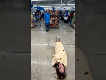 Woman wrapped in tortilla blanket in store aisle