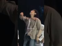 Person performing energetically on stage with microphone.