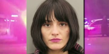Woman with dark hair and pink lipstick