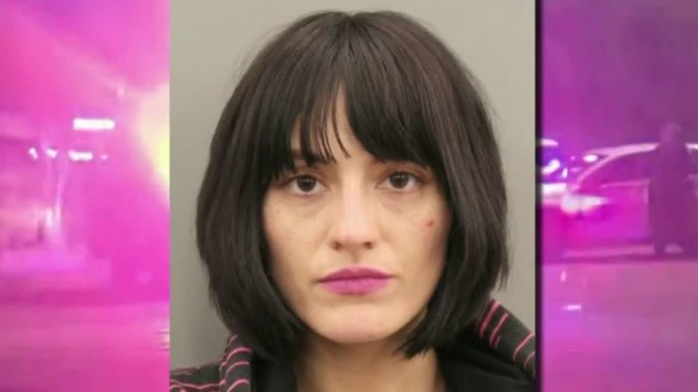 Woman with dark hair and pink lipstick