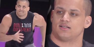 Man wearing 'Built Different' shirt, focused expression.