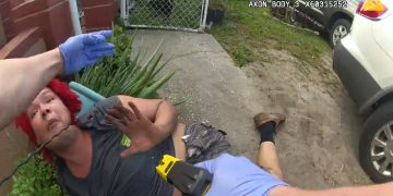 Person on ground with taser, police interaction.