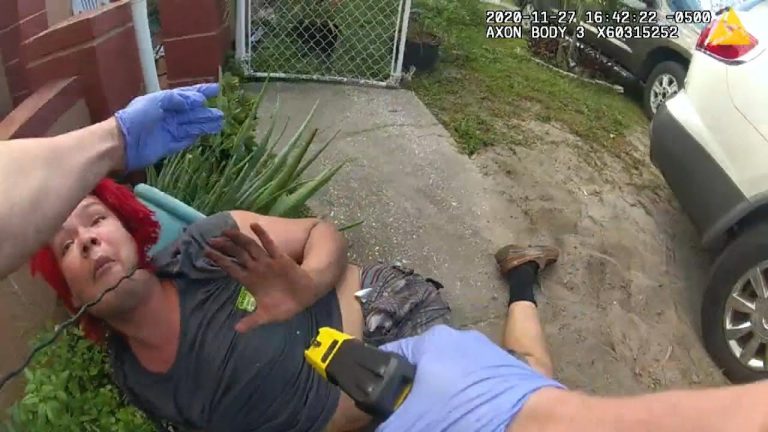 Person on ground with taser, police interaction.