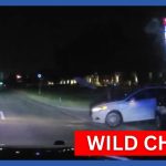 Nighttime police chase on highway captured on camera.
