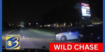 Nighttime police chase on highway captured on camera.