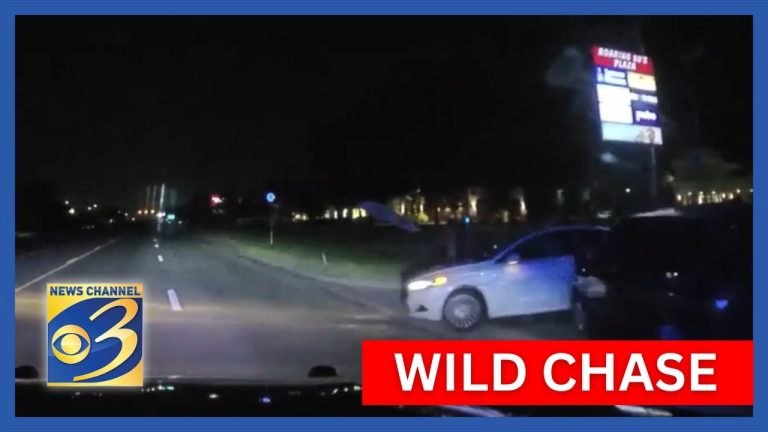 Nighttime police chase on highway captured on camera.