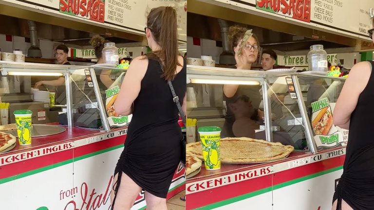 Woman buying pizza at a food counter.