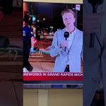 Reporter speaking during Grand Rapids fireworks event.