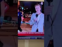 Reporter speaking during Grand Rapids fireworks event.