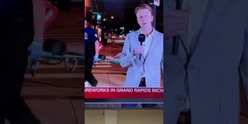 Reporter speaking during Grand Rapids fireworks event.