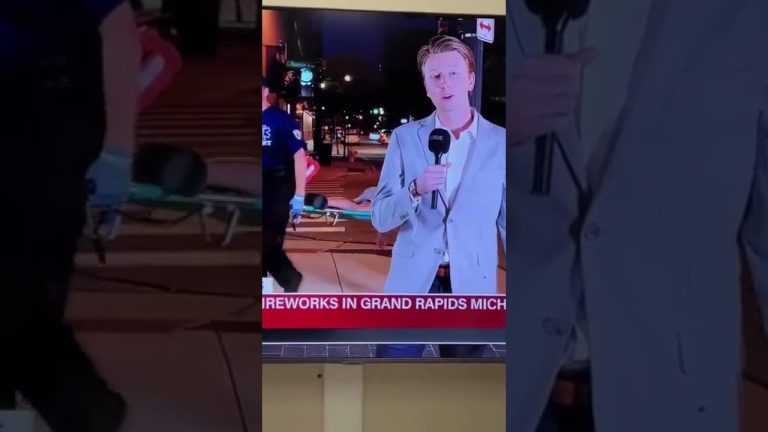 Reporter speaking during Grand Rapids fireworks event.