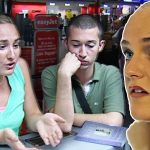 Three people talking at airport terminal desk