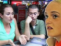 Three people talking at airport terminal desk